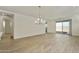 Bright living room featuring an elegant chandelier, tile floors, and sliding glass doors to the backyard at 4948 W Walatowa St, Laveen, AZ 85339