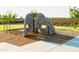 Climbing structure on playground with wood chip base surrounded by green grass at 4948 W Walatowa St, Laveen, AZ 85339