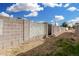 Dirt backyard featuring a tall cinder block fence and sparse vegetation at 525 S 99Th St, Mesa, AZ 85208