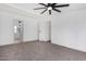 Large bedroom featuring neutral carpet, ceiling fan, and access to ensuite bathroom at 525 S 99Th St, Mesa, AZ 85208