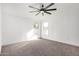 Spacious bedroom with plush carpet, ceiling fan, and windows for natural light at 525 S 99Th St, Mesa, AZ 85208