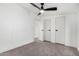 Bedroom with neutral carpet, ceiling fan, and access to closet and hallway at 525 S 99Th St, Mesa, AZ 85208