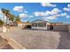 Neutral-colored home with a low maintenance yard, privacy fence, and tall palm trees at 525 S 99Th St, Mesa, AZ 85208