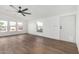 Bright living area featuring wood-look floors, a ceiling fan, and lots of natural light at 525 S 99Th St, Mesa, AZ 85208