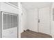 Hallway featuring clean white walls and doors, with durable flooring, and air conditioning unit at 525 S 99Th St, Mesa, AZ 85208