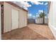 Storage shed in the backyard surrounded by dirt landscaping and block wall at 525 S 99Th St, Mesa, AZ 85208