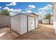 Exterior shot of backyard shed with additional storage in the distance, surrounded by dirt landscaping at 525 S 99Th St, Mesa, AZ 85208