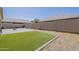 Lush backyard featuring well-maintained artificial grass and block wall fence at 5360 S 98Th Pl, Mesa, AZ 85212