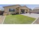 Manicured backyard with artificial turf, fire pit, covered patio, and privacy fence create an inviting outdoor space at 5360 S 98Th Pl, Mesa, AZ 85212