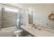 Bathroom featuring a shower-tub combo, decorative curtain, gray tile, and a large mirror above the sink at 5360 S 98Th Pl, Mesa, AZ 85212