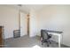 Small bedroom with carpeted floors, neutral walls, a desk, and a traditional dresser at 5360 S 98Th Pl, Mesa, AZ 85212