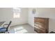 Bedroom with a natural-toned dresser, carpeted floors, bright natural light, and neutral walls at 5360 S 98Th Pl, Mesa, AZ 85212