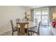 Cozy dining room features a round table, neutral paint, and sliding glass doors to the outdoor patio at 5360 S 98Th Pl, Mesa, AZ 85212