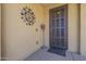 Welcoming front entrance with a decorative metal sunburst and a stylish screen door at 5360 S 98Th Pl, Mesa, AZ 85212