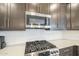 Close-up of the kitchen features stainless steel appliances, modern white backsplash, and gas range at 5360 S 98Th Pl, Mesa, AZ 85212