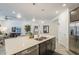 Modern kitchen island featuring a double sink, stainless steel dishwasher and seating for three at 5360 S 98Th Pl, Mesa, AZ 85212