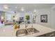 Open-concept kitchen with a large island, undermount sink, and a view into the living room at 5360 S 98Th Pl, Mesa, AZ 85212