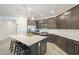 Modern kitchen featuring a spacious island, stainless steel appliances, and dark wood cabinetry at 5360 S 98Th Pl, Mesa, AZ 85212