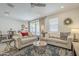 Bright living area featuring neutral walls, ceiling fan, and comfortable sofas at 5360 S 98Th Pl, Mesa, AZ 85212