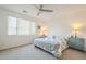 Bright main bedroom featuring a ceiling fan, large window, and neutral-toned decor at 5360 S 98Th Pl, Mesa, AZ 85212