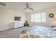 Comfortable bedroom featuring neutral tones, a mounted TV, and natural light at 5360 S 98Th Pl, Mesa, AZ 85212