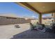 Relaxing covered patio featuring comfortable outdoor furniture, a fire pit, and a spacious, paved area at 5360 S 98Th Pl, Mesa, AZ 85212