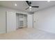 Bright bedroom with neutral carpet, ceiling fan, closet, and white trim at 5449 E Cambridge Ave, Phoenix, AZ 85008