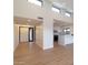 Bright, open-concept living room with light wood floors leads into the kitchen, with high ceilings and ample natural light at 5449 E Cambridge Ave, Phoenix, AZ 85008