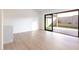 Bright living room with wood floors, a marble topped counter, and large sliding doors to backyard at 5449 E Cambridge Ave, Phoenix, AZ 85008