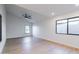 This bright living room has a ceiling fan, light wood floors, and a large window at 5449 E Cambridge Ave, Phoenix, AZ 85008