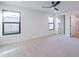 This main bedroom has neutral carpet, a ceiling fan, and two large windows at 5449 E Cambridge Ave, Phoenix, AZ 85008