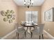 Formal dining room with stylish table, chairs, chandelier, and decorative wall art at 560 E Rainbow Dr, Chandler, AZ 85249