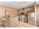 Spacious kitchen with stainless steel appliances, breakfast bar, and ample cabinet space at 560 E Rainbow Dr, Chandler, AZ 85249