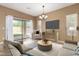 Comfortable living room with ample seating, backyard access, and stylish decor at 560 E Rainbow Dr, Chandler, AZ 85249