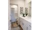 Modern bathroom with white cabinets, double sink, decorative mirrors, and a shower/tub combo with patterned curtain at 624 N Vine St, Chandler, AZ 85225