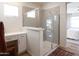 Modern bathroom features a glass-enclosed shower with tiled walls and a vanity area with a makeup table at 624 N Vine St, Chandler, AZ 85225