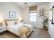 Bright bedroom with a woven headboard, white bedding, and eclectic decor for a cozy and stylish space at 624 N Vine St, Chandler, AZ 85225