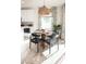 Cozy dining area featuring a round table, stylish woven chairs, natural light, and tasteful decor, adjacent to kitchen at 624 N Vine St, Chandler, AZ 85225