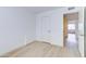 The bright bedroom features new light-colored floors, white trim, and a door to patio at 6333 N 49Th Ave, Glendale, AZ 85301