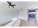 Bedroom featuring wood-look flooring, a ceiling fan, and a closet with sliding doors at 6333 N 49Th Ave, Glendale, AZ 85301