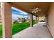 View of the shaded back patio overlooking lush green grass and landscaping at 7118 E Juanita Ave, Mesa, AZ 85209