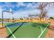 Outdoor basketball court view bordered by palm trees and homes under a partly cloudy sky at 7118 E Juanita Ave, Mesa, AZ 85209