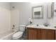 Traditional bathroom featuring a shower-tub combo, wood vanity, mirror, and tiled walls at 7118 E Juanita Ave, Mesa, AZ 85209