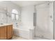 Bright bathroom with soaking tub, glass shower, and framed mirror at 7118 E Juanita Ave, Mesa, AZ 85209