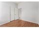 Empty bedroom with hardwood floors and standard double closet doors at 7118 E Juanita Ave, Mesa, AZ 85209