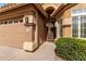 Close-up of the front entrance showcasing a decorative front door and well-maintained landscaping at 7118 E Juanita Ave, Mesa, AZ 85209