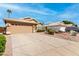 A single-story home featuring a well maintained two-car garage and desert landscaping at 7118 E Juanita Ave, Mesa, AZ 85209