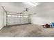 Spacious garage with a rolling garage door and paint cans at 7118 E Juanita Ave, Mesa, AZ 85209