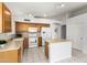 Well-equipped kitchen with wooden cabinets, modern appliances, and tile flooring at 7118 E Juanita Ave, Mesa, AZ 85209