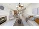 Inviting living room with a fireplace and seamlessly connected dining area at 7118 E Juanita Ave, Mesa, AZ 85209